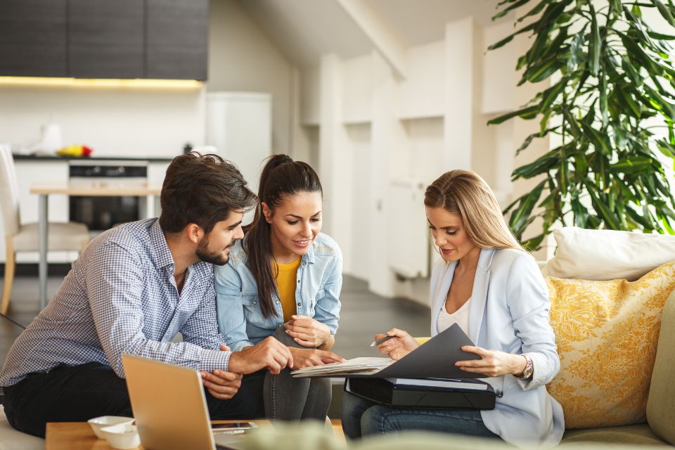 couple planning renovation with local flooring store designer in couples living room